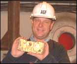 CEO Bill Trew proudly displays the first gold bar 